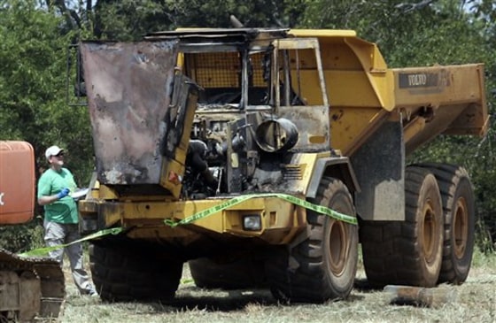 Rutherford County Sheriff's Office and ATF investigators examine equipment damaged in a fire at the site of a planned Islamic center in Murfreesboro on Saturday.